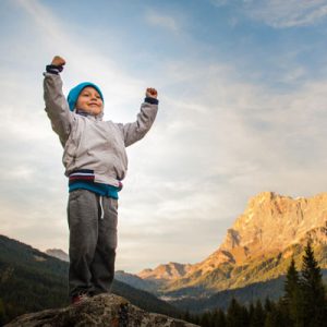 Enfant heureux aux pieds d'une montagne